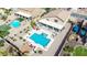 A luxurious backyard includes an inviting pool, lounge areas, and covered patio at 565 E Rosebud Dr, San Tan Valley, AZ 85143
