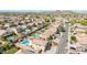 Expansive aerial view of a residential community with private pools and desert mountain backdrop at 565 E Rosebud Dr, San Tan Valley, AZ 85143