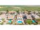 Aerial view of homes with pools in a lush neighborhood, near vast open fields at 565 E Rosebud Dr, San Tan Valley, AZ 85143