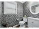 Stylish powder room with black and white patterned wallpaper and modern fixtures at 565 E Rosebud Dr, San Tan Valley, AZ 85143