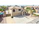 Inviting two-story home featuring a three-car garage, neutral stucco and tile roof at 565 E Rosebud Dr, San Tan Valley, AZ 85143