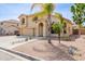 Inviting two-story house featuring desert landscaping, mature trees, and a cozy front entrance at 565 E Rosebud Dr, San Tan Valley, AZ 85143