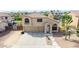 Inviting two-story home featuring a three-car garage, neutral stucco and tile roof at 565 E Rosebud Dr, San Tan Valley, AZ 85143
