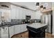 Kitchen featuring stainless steel appliances, white cabinets and custom backsplash at 565 E Rosebud Dr, San Tan Valley, AZ 85143