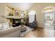 Cozy living room featuring a fireplace, high ceilings, and ample natural light at 565 E Rosebud Dr, San Tan Valley, AZ 85143