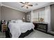 Cozy bedroom featuring a comfortable bed, a ceiling fan, and a window providing natural light at 565 E Rosebud Dr, San Tan Valley, AZ 85143