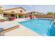 Beautiful in-ground swimming pool with desert landscaping, covered patio and lounge chairs at 565 E Rosebud Dr, San Tan Valley, AZ 85143