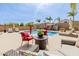 Inviting backyard pool featuring a lounge area and red cushioned seating at 565 E Rosebud Dr, San Tan Valley, AZ 85143