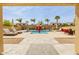 Backyard swimming pool with lounge chairs, patio furniture and desert landscaping at 565 E Rosebud Dr, San Tan Valley, AZ 85143
