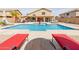 Spacious pool with desert landscaping, patio and outdoor furniture for relaxing at 565 E Rosebud Dr, San Tan Valley, AZ 85143