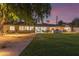 Large backyard with lush lawn, patio, built-in grill, and mature trees at 5960 E Orange Blossom Ln, Phoenix, AZ 85018