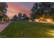Expansive backyard features lush green lawn, mature trees, and privacy landscaping, perfect for outdoor activities and relaxation at 5960 E Orange Blossom Ln, Phoenix, AZ 85018