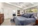 Bright bedroom featuring a ceiling fan, ensuite bath, and large windows at 5960 E Orange Blossom Ln, Phoenix, AZ 85018
