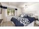 Stylish bedroom with a large window, modern lighting, and comfortable furnishings at 5960 E Orange Blossom Ln, Phoenix, AZ 85018