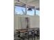 Dining room with a large wooden table, modern light fixture, and views from clerestory windows at 5960 E Orange Blossom Ln, Phoenix, AZ 85018