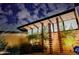 Stunning modern home exterior features unique architectural details and desert-friendly landscaping with dramatic lighting at 5960 E Orange Blossom Ln, Phoenix, AZ 85018