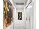 Hallway decorated with modern artwork with white walls, tile flooring, and a recessed lighting at 5960 E Orange Blossom Ln, Phoenix, AZ 85018