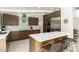 Gourmet kitchen featuring an island with seating, stainless steel appliances, and modern cabinetry at 5960 E Orange Blossom Ln, Phoenix, AZ 85018