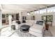Open living room showcases a white sectional, clerestory windows and seamless flow to the kitchen at 5960 E Orange Blossom Ln, Phoenix, AZ 85018