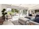 Airy open concept living area boasts a comfortable sectional and large slider to a lovely patio at 5960 E Orange Blossom Ln, Phoenix, AZ 85018