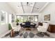 Chic living room design with vaulted ceilings, modern lighting, and large windows overlooking lush landscaping at 5960 E Orange Blossom Ln, Phoenix, AZ 85018