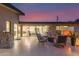 Beautiful outdoor patio with comfortable seating, an outdoor fireplace and view of the main house at 5960 E Orange Blossom Ln, Phoenix, AZ 85018