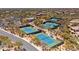 Community aerial view showcasing tennis courts, swimming pool, lush landscaping, and parking at 6522 E Night Glow Cir, Scottsdale, AZ 85266