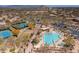 Aerial view showcasing tennis courts and a luxurious swimming pool and community amenities at 6522 E Night Glow Cir, Scottsdale, AZ 85266