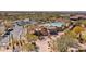 Aerial view showcasing lush landscaping, pool, parking area and community clubhouse at 6522 E Night Glow Cir, Scottsdale, AZ 85266