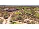 Aerial view of golf course with green fairways, desert vegetation, and a clubhouse at 6522 E Night Glow Cir, Scottsdale, AZ 85266