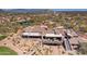 An aerial view shows the clubhouse with outdoor dining areas, and views of the community at 6522 E Night Glow Cir, Scottsdale, AZ 85266