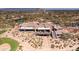 Stunning aerial view of clubhouse featuring dining, a nearby pool, golf course, and desert landscaping at 6522 E Night Glow Cir, Scottsdale, AZ 85266