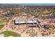 Aerial view of clubhouse with golf course, desert landscaping, and community in background at 6522 E Night Glow Cir, Scottsdale, AZ 85266