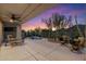 Evening shot of backyard area with colorful skies, desert landscaping, and relaxing water feature at 6522 E Night Glow Cir, Scottsdale, AZ 85266