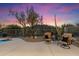 Backyard area at night featuring desert landscaping, seating area, and mountain views at 6522 E Night Glow Cir, Scottsdale, AZ 85266