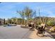 Backyard area showcasing the desert landscaping, mountain views, and a small water feature at 6522 E Night Glow Cir, Scottsdale, AZ 85266