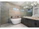 Modern bathroom featuring a soaking tub, glass shower, and gray vanity at 6522 E Night Glow Cir, Scottsdale, AZ 85266