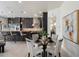 An open dining area with table and chairs, modern black cabinets, and bar stool seating at 6522 E Night Glow Cir, Scottsdale, AZ 85266