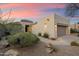 A home with desert landscaping featuring rocks, gravel, and green plants at 6522 E Night Glow Cir, Scottsdale, AZ 85266