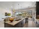 Large kitchen island featuring granite countertops, stainless steel sink, and view to the outdoor patio at 6522 E Night Glow Cir, Scottsdale, AZ 85266