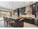 Kitchen island with bar stool seating, stainless steel appliances, and stone countertops at 6522 E Night Glow Cir, Scottsdale, AZ 85266