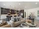 Bright living room with white walls, tile floor, and open layout to kitchen at 6522 E Night Glow Cir, Scottsdale, AZ 85266