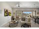 Bright living room with white walls, tile floor, ceiling fan, and sliding glass doors to patio at 6522 E Night Glow Cir, Scottsdale, AZ 85266
