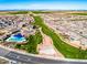 Aerial view of the neighborhood featuring the community green spaces, pool, walking paths, and Gathering-friendly amenities at 690 W Mangrove Rd, Queen Creek, AZ 85140