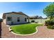 The backyard is beautifully landscaped with a fire pit and artificial turf at 690 W Mangrove Rd, Queen Creek, AZ 85140