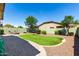 Well-kept backyard featuring artificial turf, a fire pit, and desert landscaping at 690 W Mangrove Rd, Queen Creek, AZ 85140