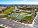 An aerial view of a park featuring basketball courts, walking trails, picnic area, and neighborhood scenery at 690 W Mangrove Rd, Queen Creek, AZ 85140