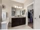 Stylish bathroom vanity with double sinks and a large mirror plus access to a walk-in closet at 690 W Mangrove Rd, Queen Creek, AZ 85140