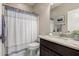 Bathroom with granite countertop, dark wood cabinets, shower-tub combo and modern fixtures at 690 W Mangrove Rd, Queen Creek, AZ 85140