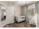 Neutral Bedroom features a white crib, wood floors, calming curtains, and decorative teepee at 690 W Mangrove Rd, Queen Creek, AZ 85140